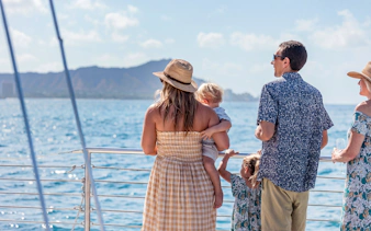 Family enjoying Waikiki sail with view of Diamond Head in the background.
