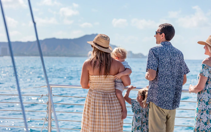 Family enjoying Waikiki sail with view of Diamond Head in the background.