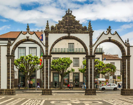 Portas da Cidade arches in Ponta Delgada, Azores with surrounding buildings.