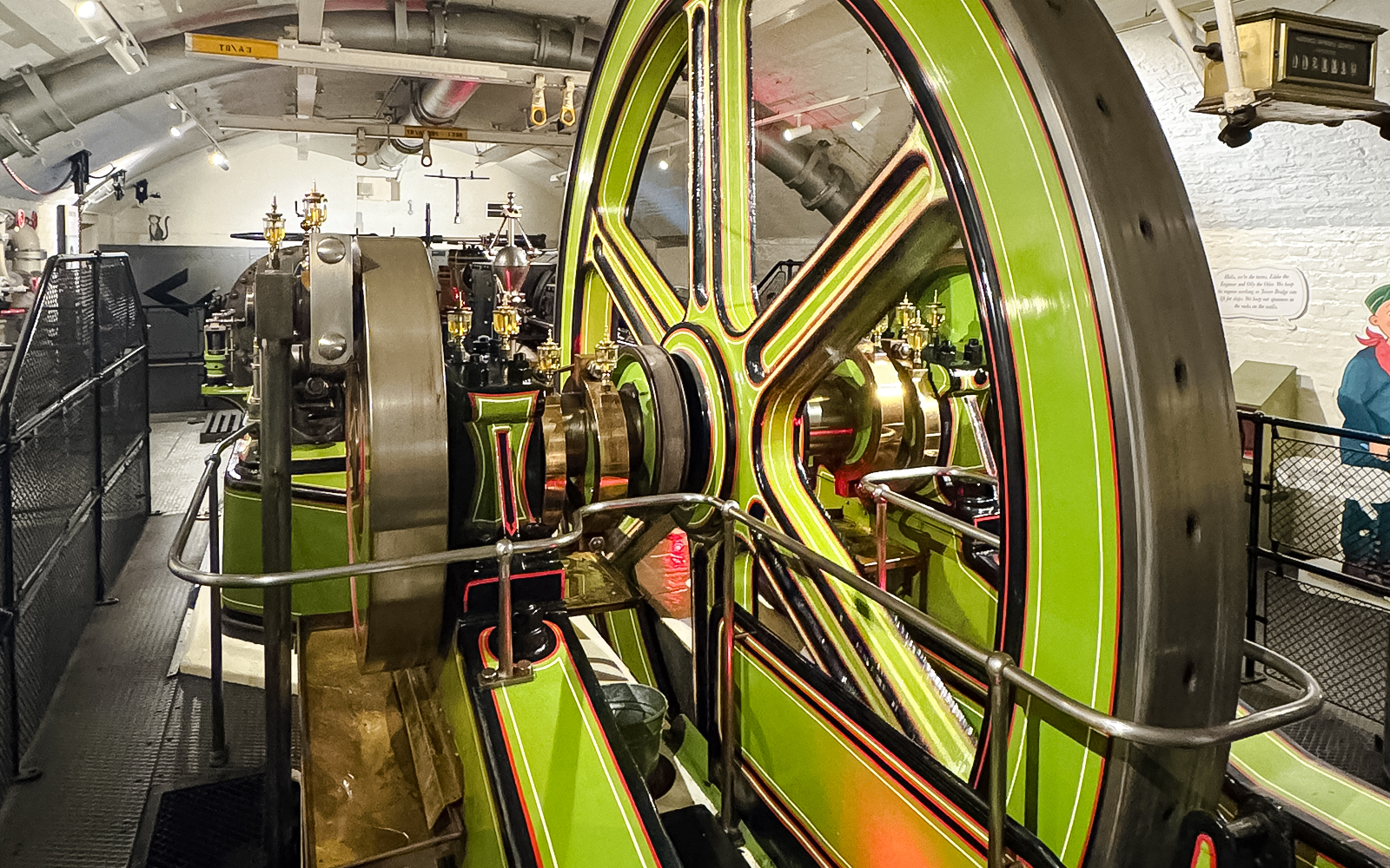 Tower Bridge engine room with large green and brass machinery components.