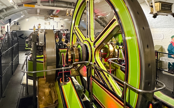 Tower Bridge engine room with large green and brass machinery components.