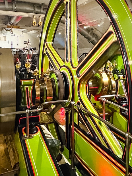 Tower Bridge engine room with large green and brass machinery components.
