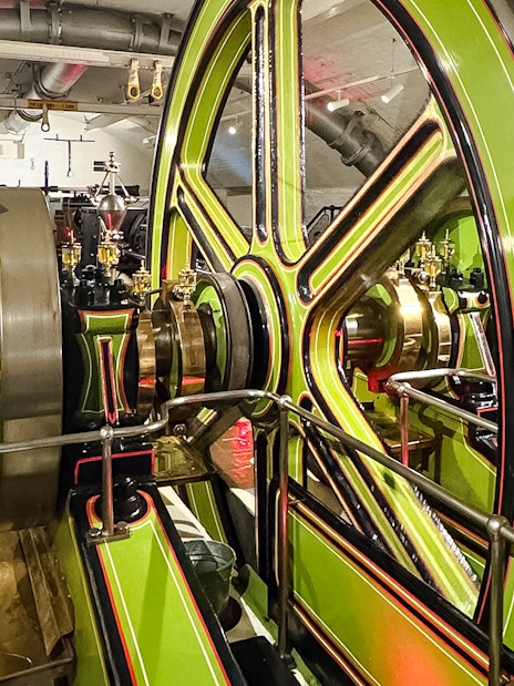 Tower Bridge engine room with large green and brass machinery components.