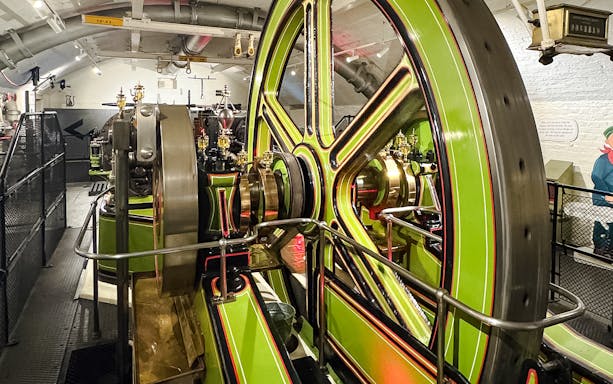 Tower Bridge engine room with large green and brass machinery components.