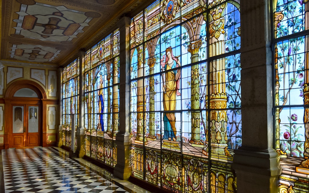 Stained glass windows inside Chapultepec Castle, Mexico City, depicting historical figures.