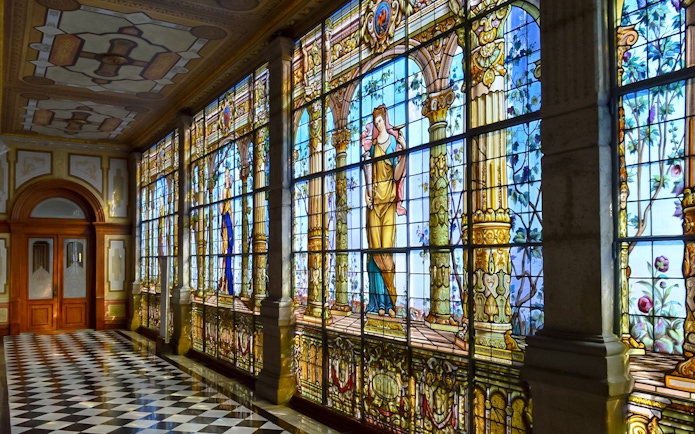Stained glass windows inside Chapultepec Castle, Mexico City, depicting historical figures.