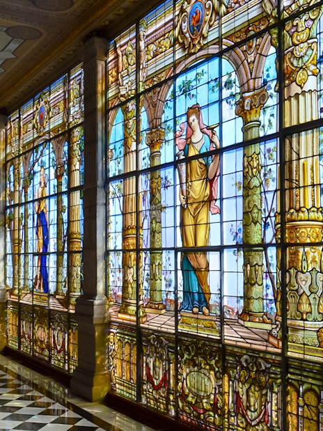 Stained glass windows inside Chapultepec Castle, Mexico City, depicting historical figures.