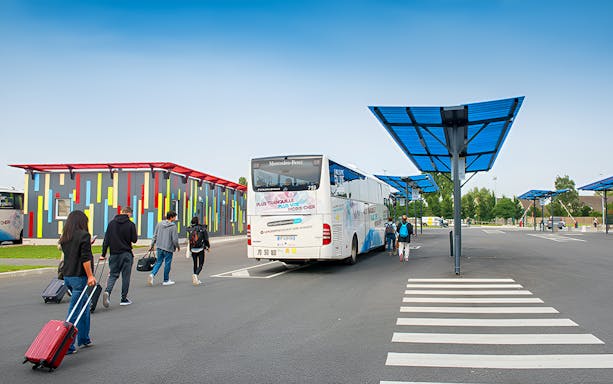 Passengers boarding a bus at Paris Beauvais Airport for a return trip to Paris.