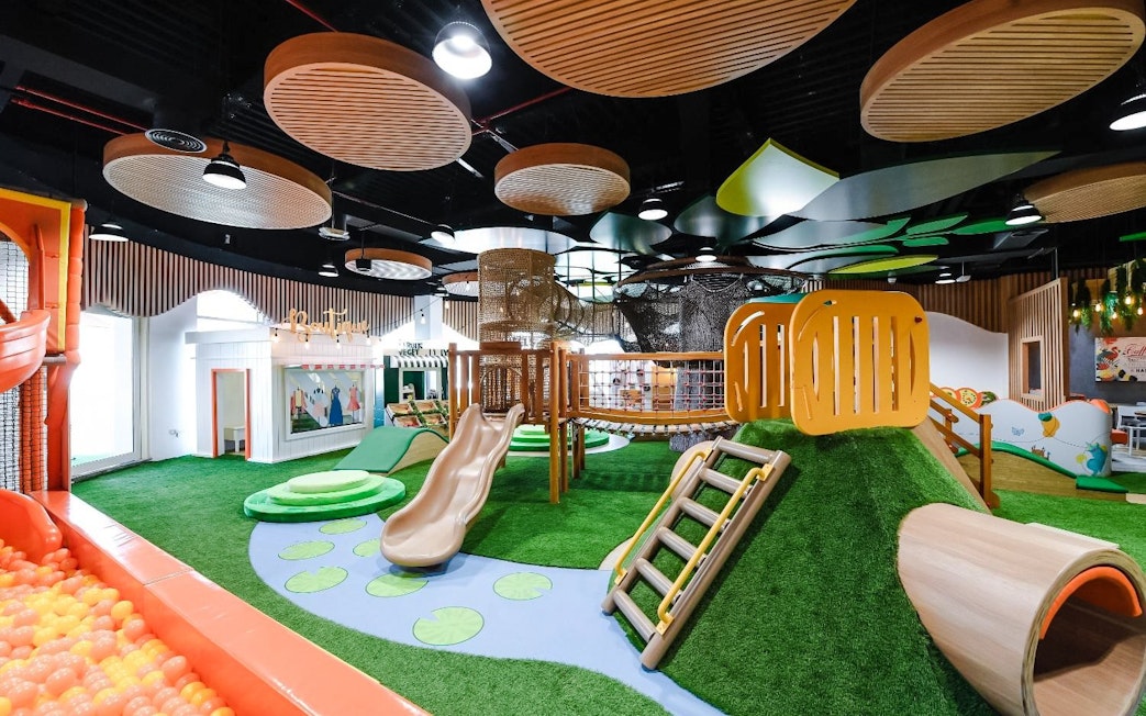 Indoor play area with slides and climbing structures at Orange Wheels, Global Village, Dubai.