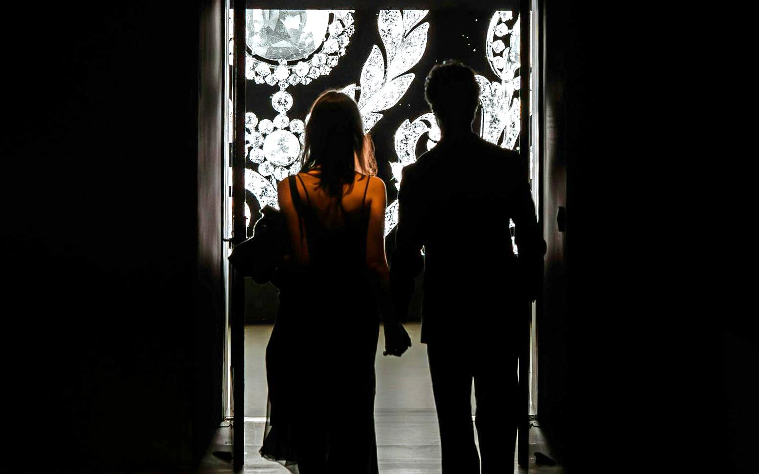 Silhouettes of two people entering Cartier Exhibition at National Gallery Victoria.