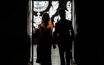Silhouettes of two people entering Cartier Exhibition at National Gallery Victoria.