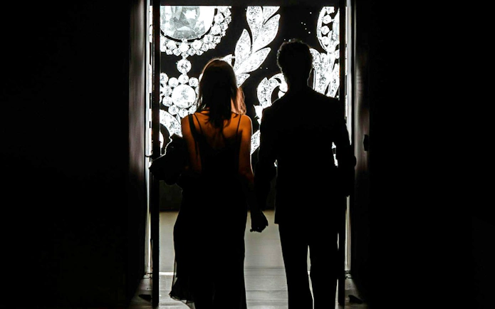 Silhouettes of two people entering Cartier Exhibition at National Gallery Victoria.