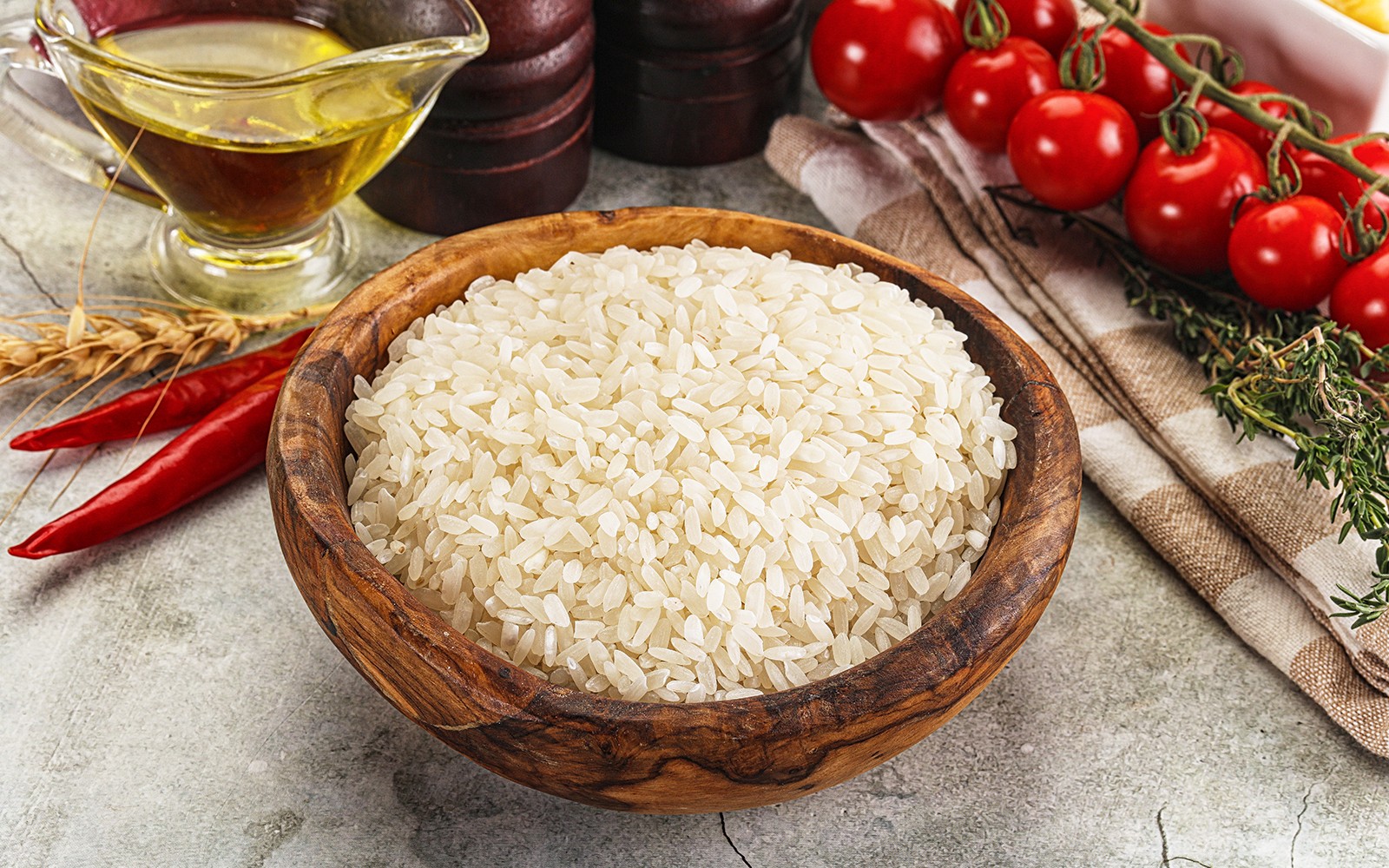 Arborio rice grains in a wooden bowl, essential for authentic Italian risotto.