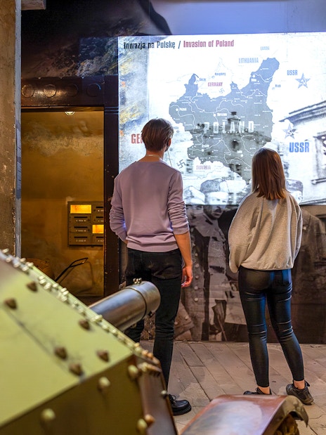 Visitors viewing historical exhibits at Oskar Schindler's Factory in Krakow, Poland.