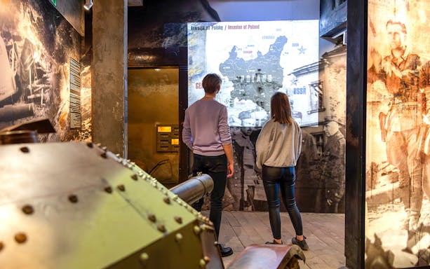 Visitors viewing historical exhibits at Oskar Schindler's Factory in Krakow, Poland.