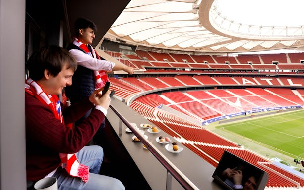 Tourists enjoying lunch while viewing Atlético de Madrid stadium from Simeone's Private Box.