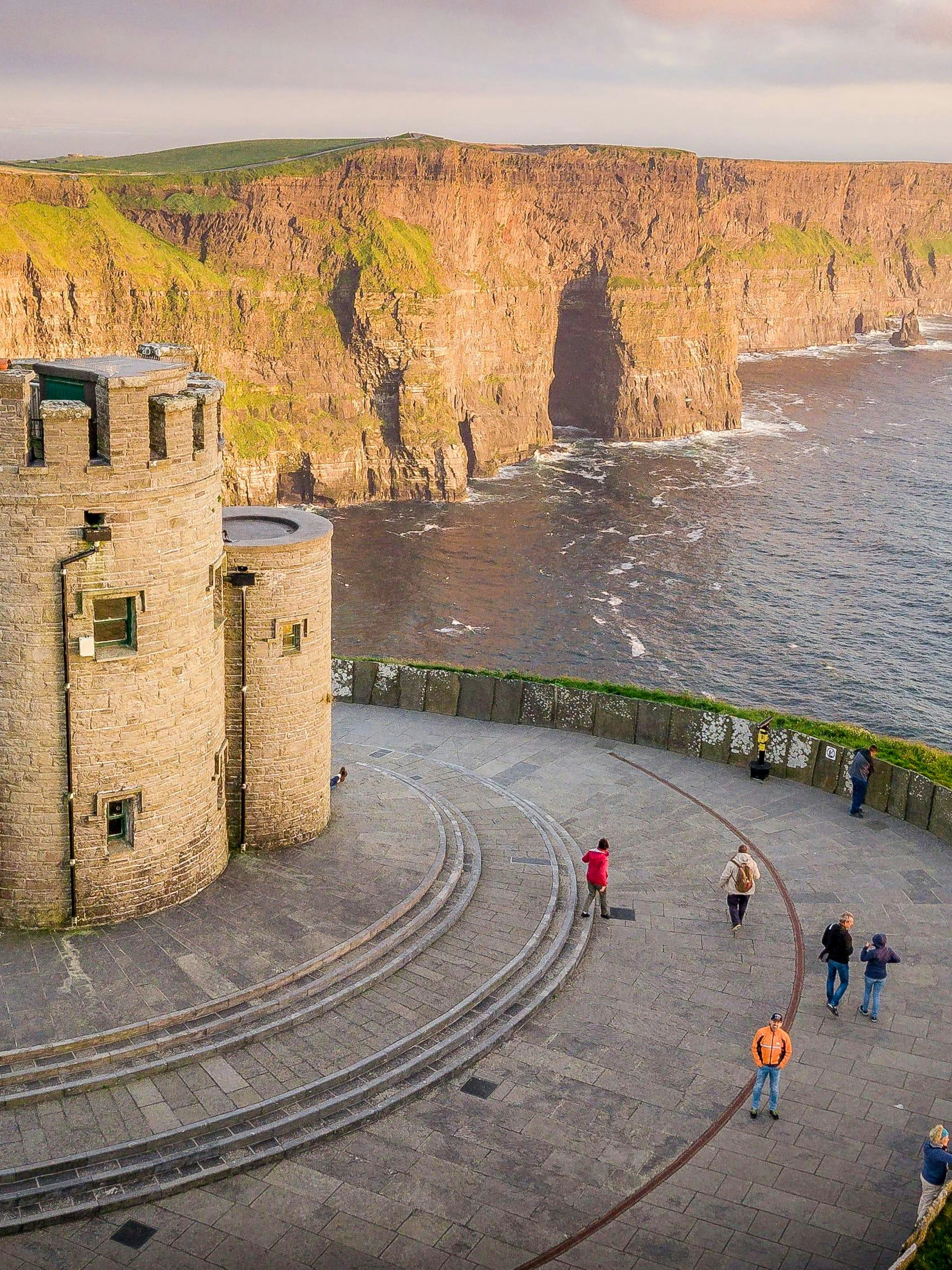 Aerial view of O'Brien's Tower at Cliffs of Moher, Ireland, with visitors exploring.