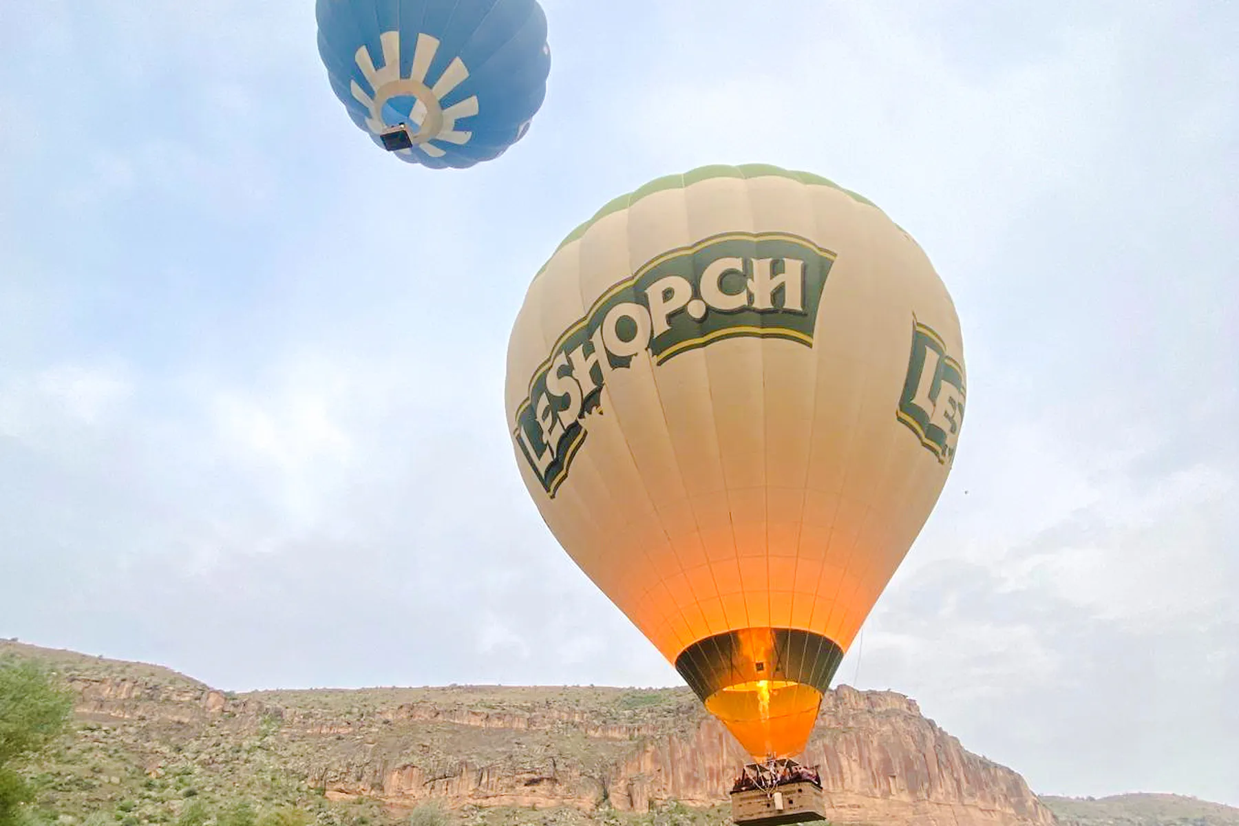 Hot air balloons flying over Ihlara Valley, Cappadocia during a scenic ride.