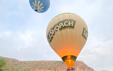 Hot air balloons flying over Ihlara Valley, Cappadocia during a scenic ride.