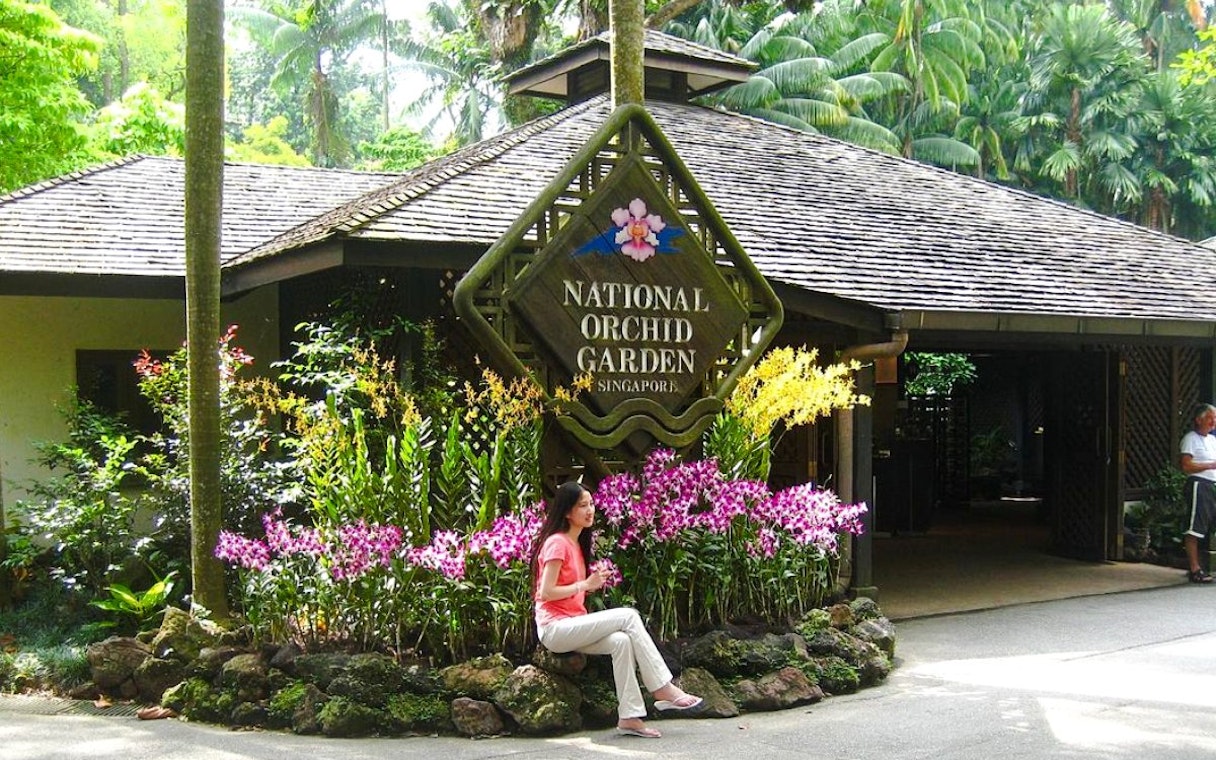 National Orchid Garden entrance with vibrant orchids, Singapore.