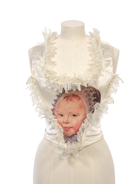 Kawakubo design with child portrait at NGV Westwood exhibition.