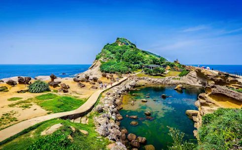 Coastal rock formations and pathways at Yehliu Geopark, New Taipei City, Taiwan.