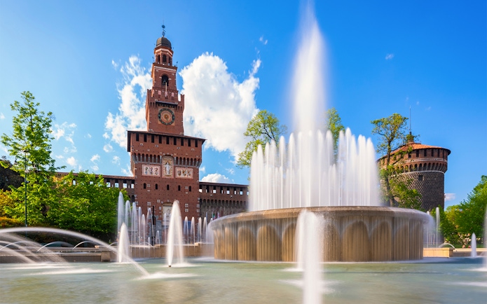 Fountain at Piazza Castello with Sforza Castle in Milan, Italy.