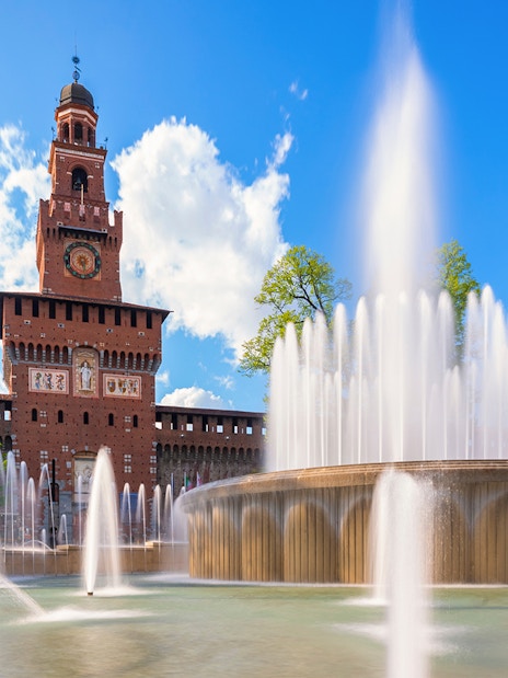 Fountain at Piazza Castello with Sforza Castle in Milan, Italy.