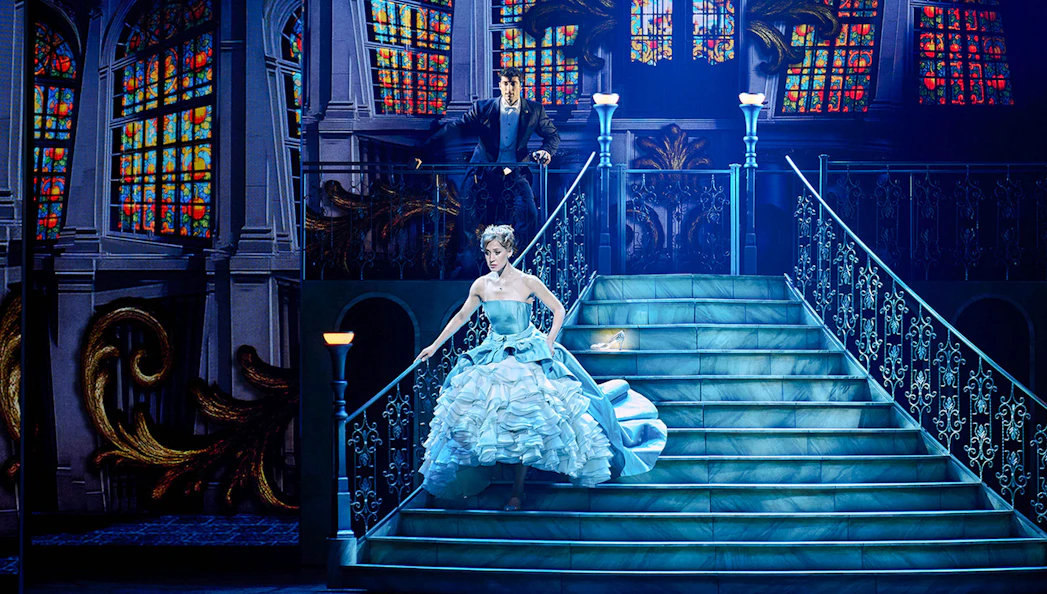Cinderella descending a grand staircase during a stage performance in Madrid.