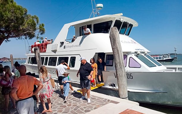 Tourists disembarking a boat at Punta Sabbioni for an afternoon trip to Murano and Burano, Venice.