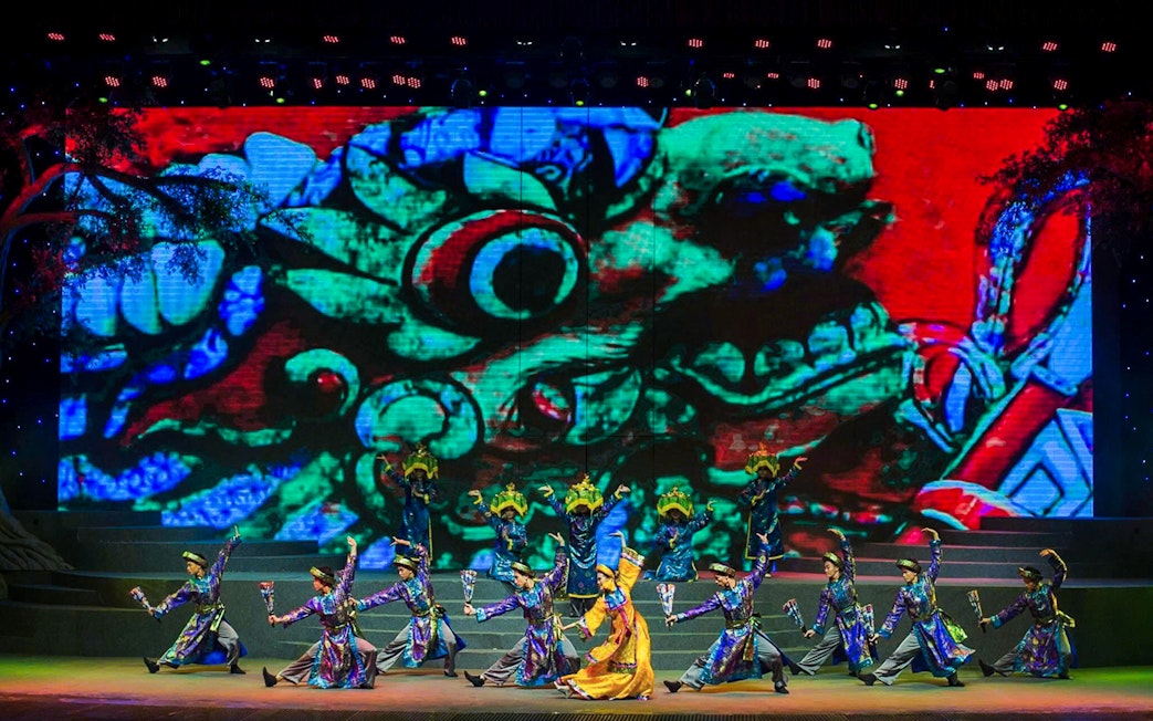 Performers in traditional costumes dance on stage at the Charming Danang Show in Da Nang.