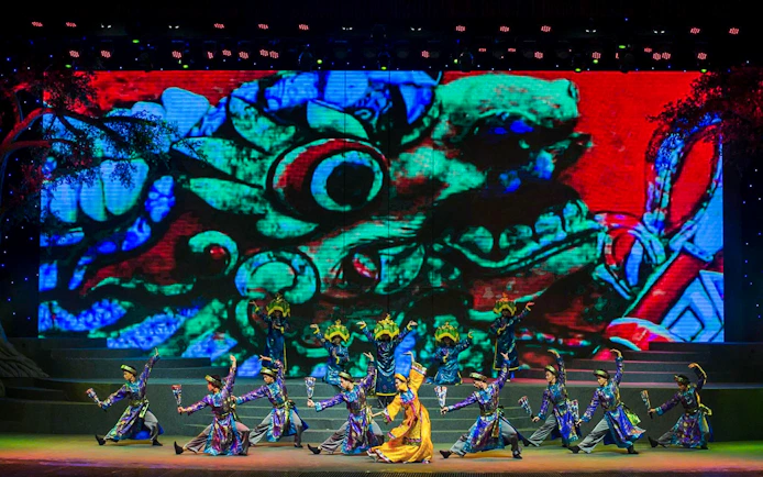 Performers in traditional costumes dance on stage at the Charming Danang Show in Da Nang.