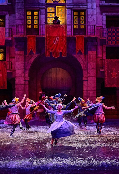 Performers in historical costumes dance in water during Dream of Toledo show.