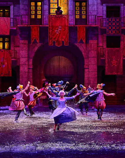 Performers in historical costumes dance in water during Dream of Toledo show.