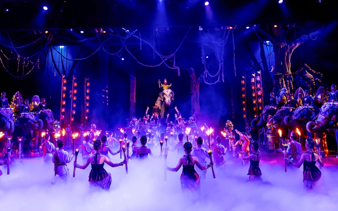 Dancers with torches performing on stage at Phuket Fantasea, Thailand.
