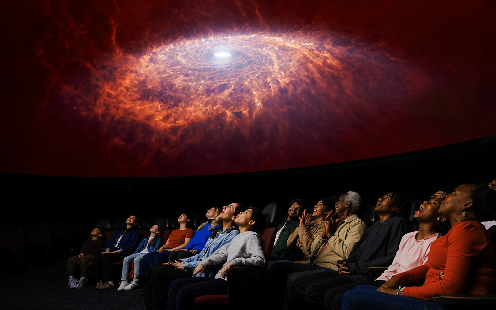 Visitors watching a galaxy projection at Encounters in the Milky Way exhibit, American Museum of Natural History.