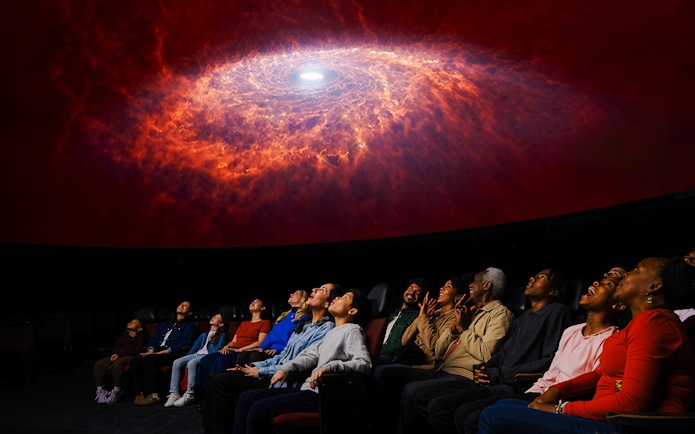 Visitors watching a galaxy projection at Encounters in the Milky Way exhibit, American Museum of Natural History.