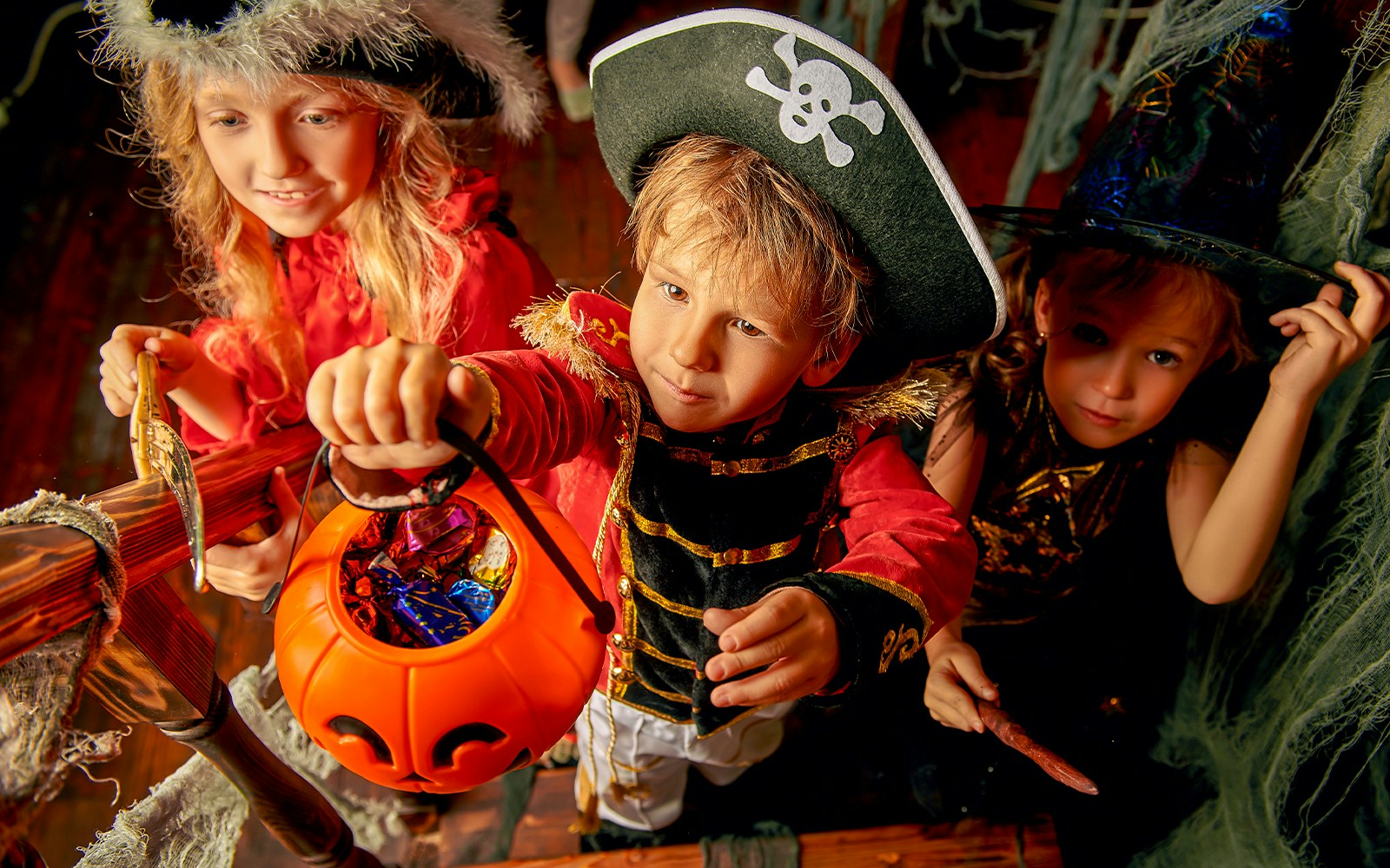 Kids in costumes collecting candies at Gardaland Halloween event in Italy