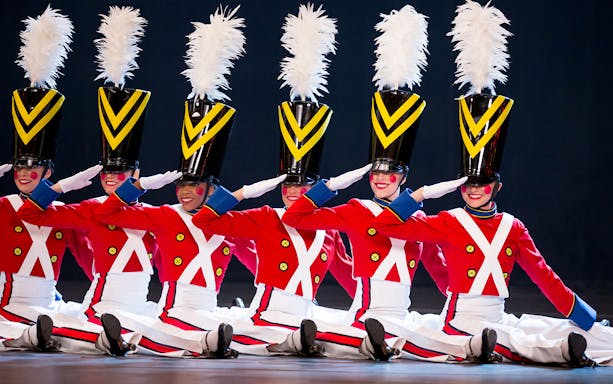Radio City Rockettes in toy soldier costumes performing at Christmas Spectacular.
