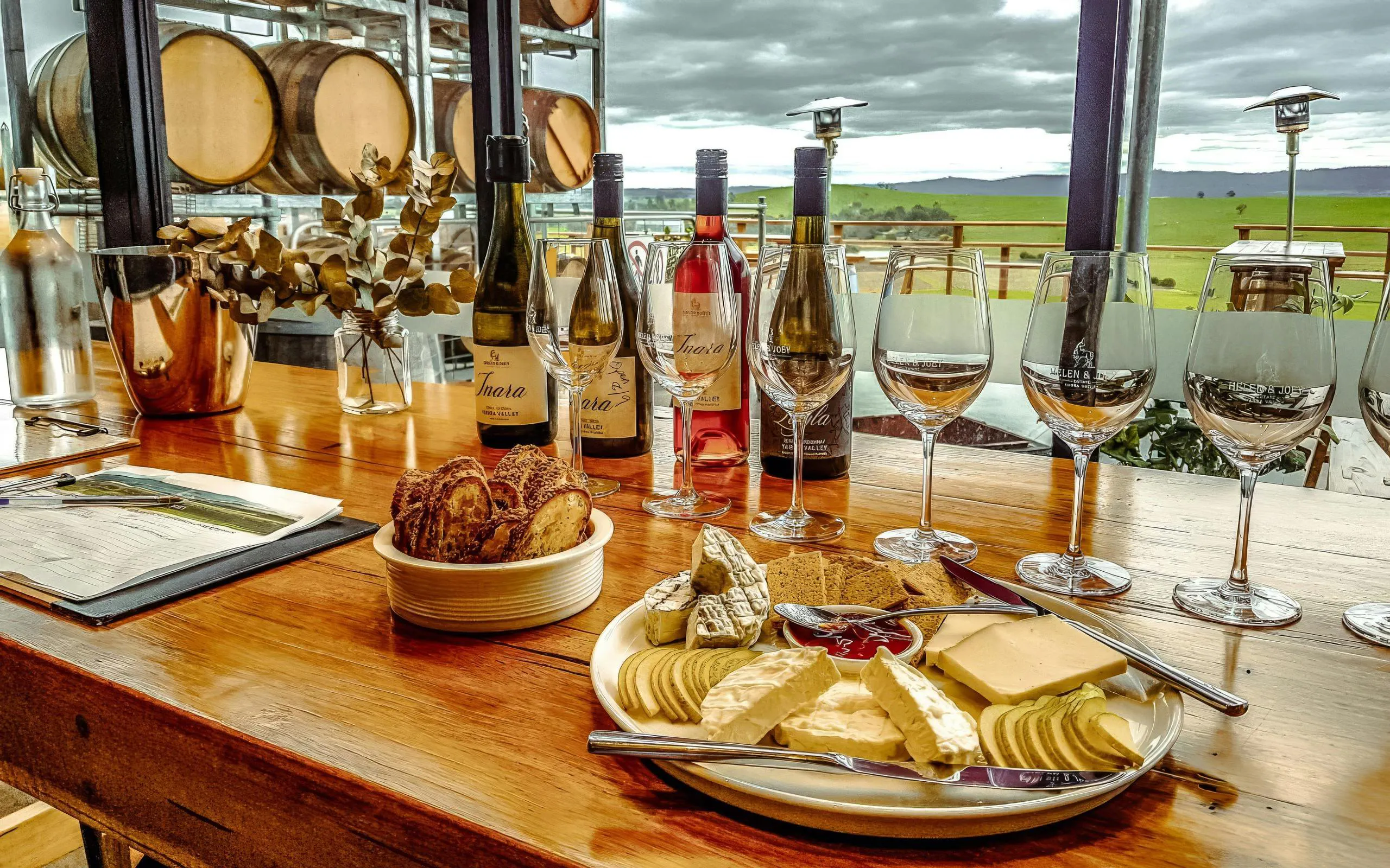 Wine tasting setup with cheese platter and wine bottles at Yarra Valley winery.