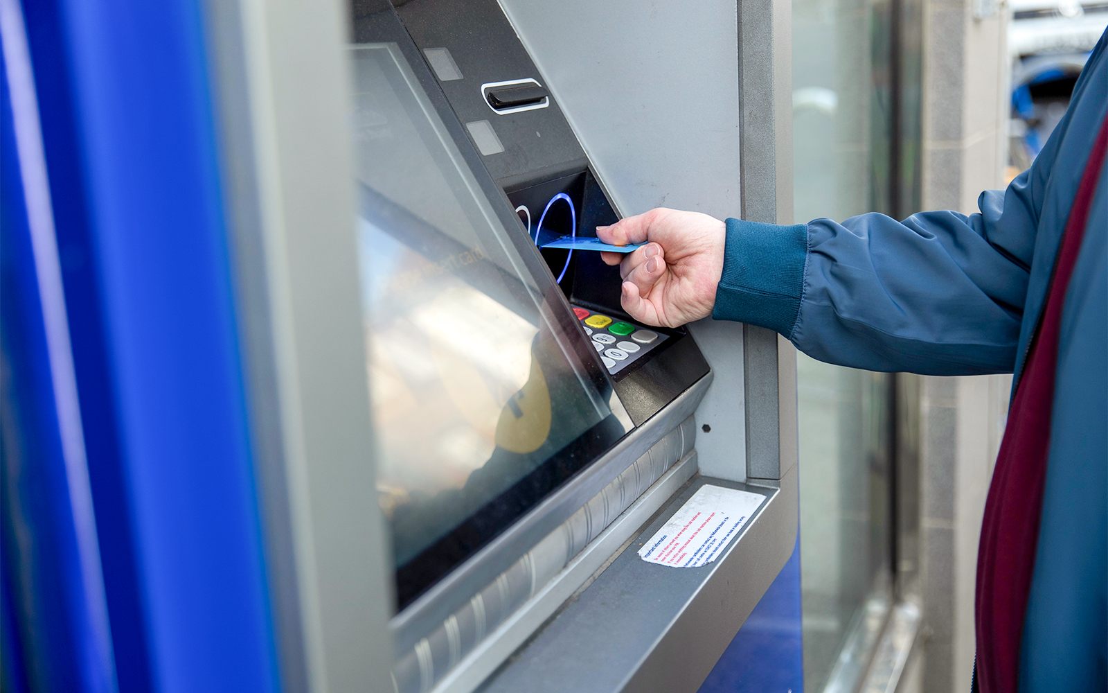 Person withdrawing money from ATM