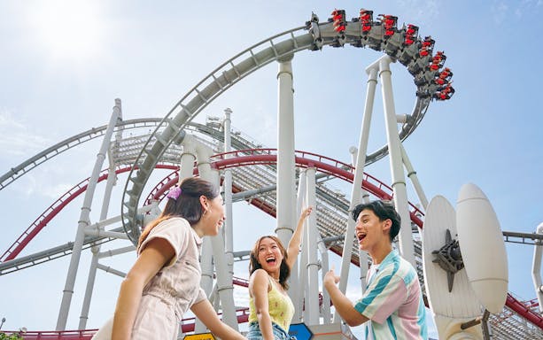 Family enjoying a roller coaster at Universal Studios Singapore.