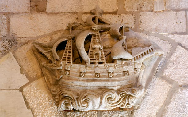 Stone carving of a ship inside the Towers of La Rochelle, France.