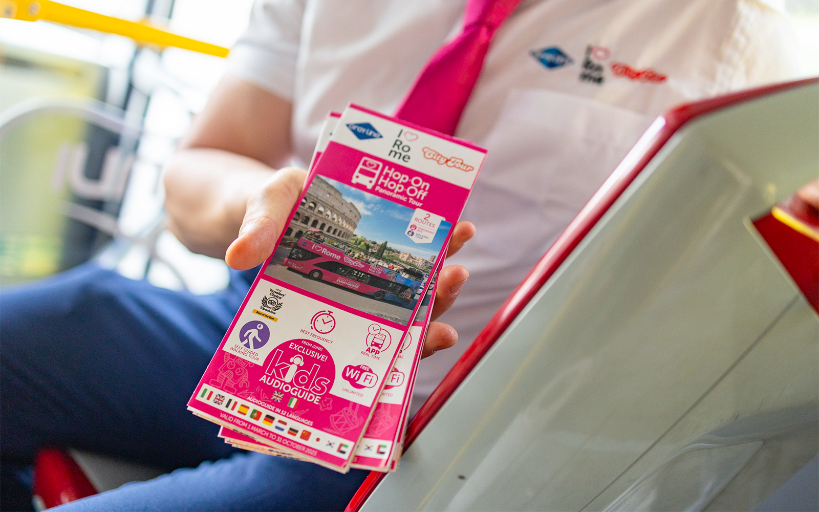 Brochure for I Love Rome Hop-On Hop-Off Tour featuring Colosseum and bus image.