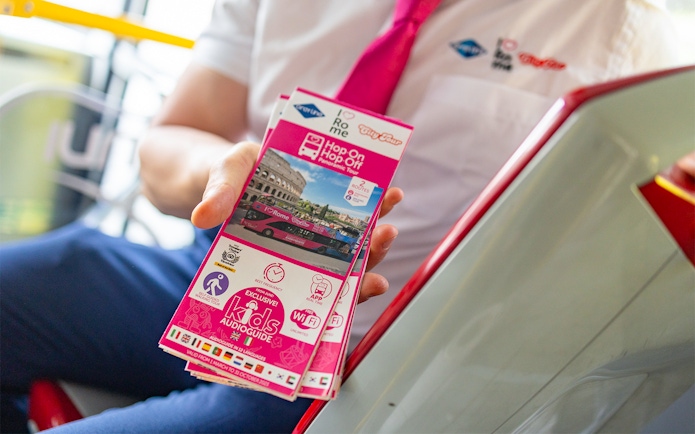 Brochure for I Love Rome Hop-On Hop-Off Tour featuring Colosseum and bus image.