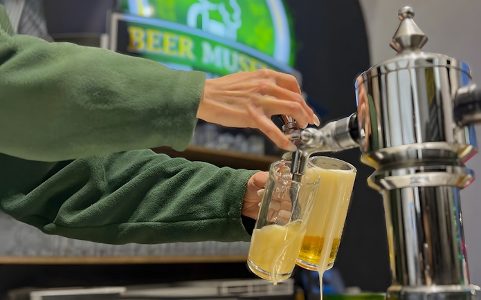 Pouring beer from a tap at Prague Beer Museum.