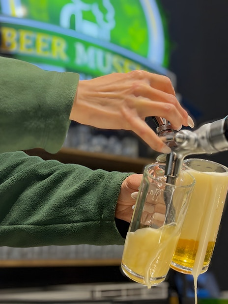 Pouring beer from a tap at Prague Beer Museum.