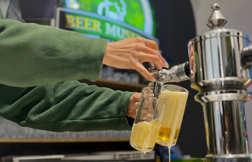 Bottling custom beer at Prague Beer Museum, showcasing historical brewing artifacts.