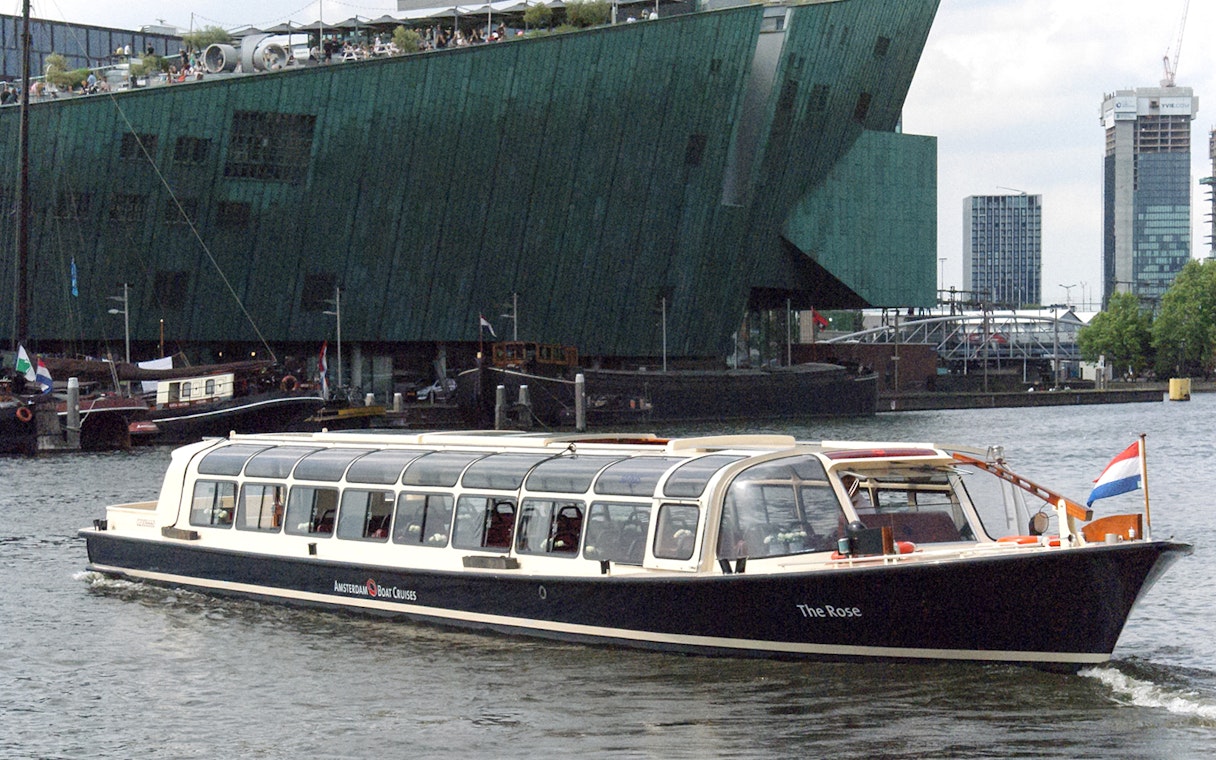 Amsterdam canal cruise boat near NEMO Science Museum.