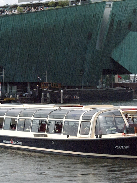 Amsterdam canal cruise boat near NEMO Science Museum.